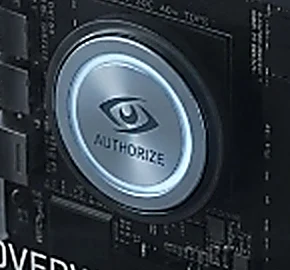 Close view of the Overwatch Node physical authorize control, an illuminated eye emblem on the front panel